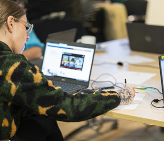 Vice chair of the RVSP taking notes and researching on laptop