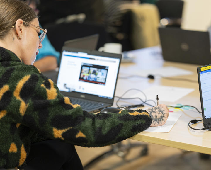 Vice chair of the RVSP taking notes and researching on laptop