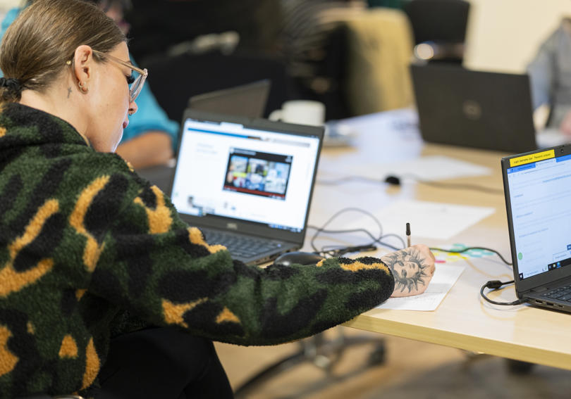 Vice chair of the RVSP taking notes and researching on laptop