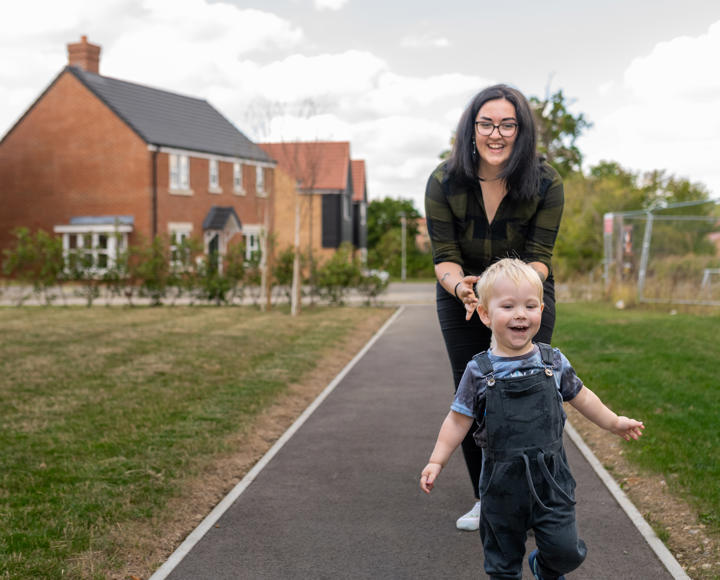 Hightown resident and her son running ahead of her in the outside communal space of a new development