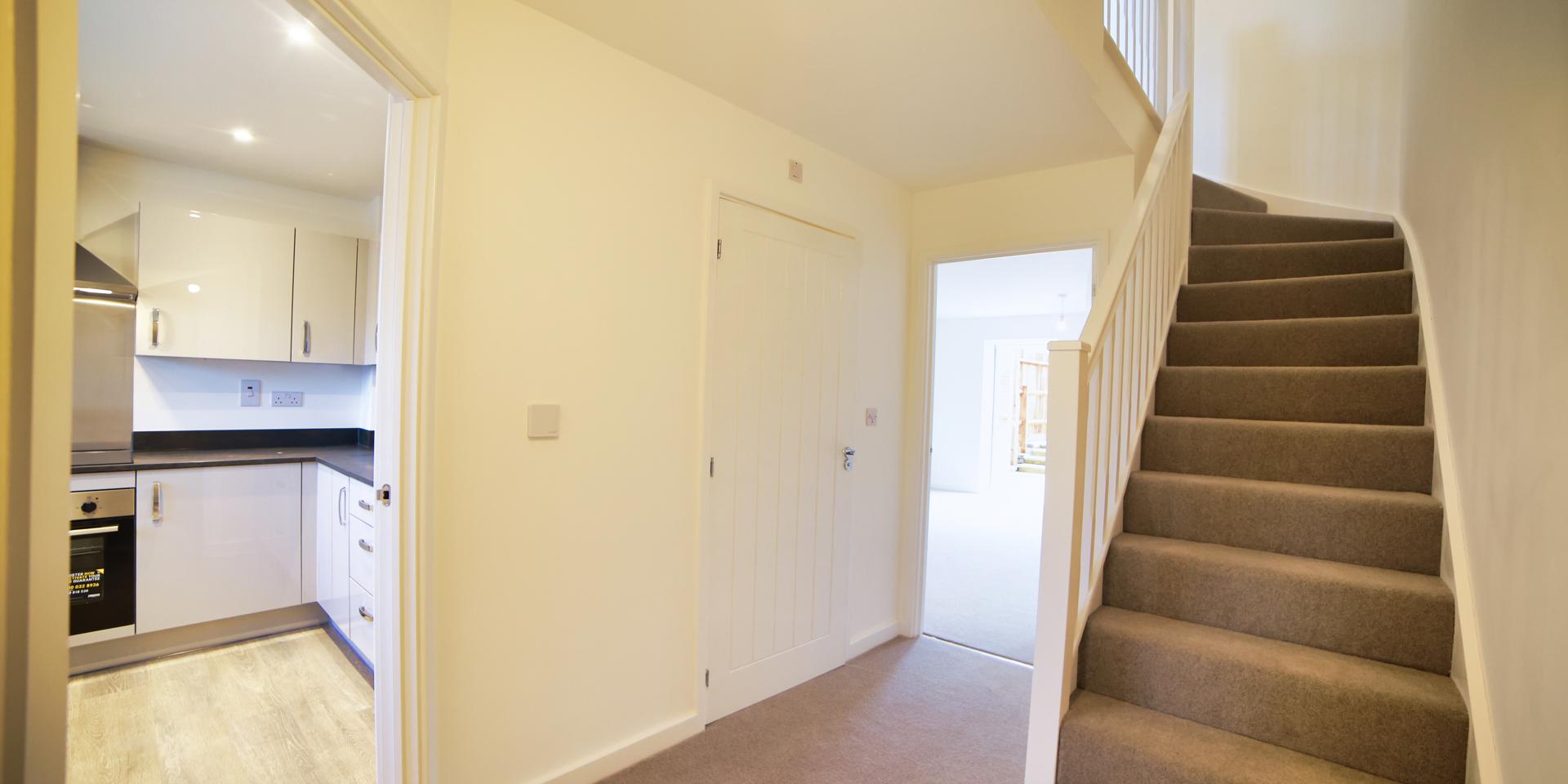 Hallway with doorway to kitchen and living area