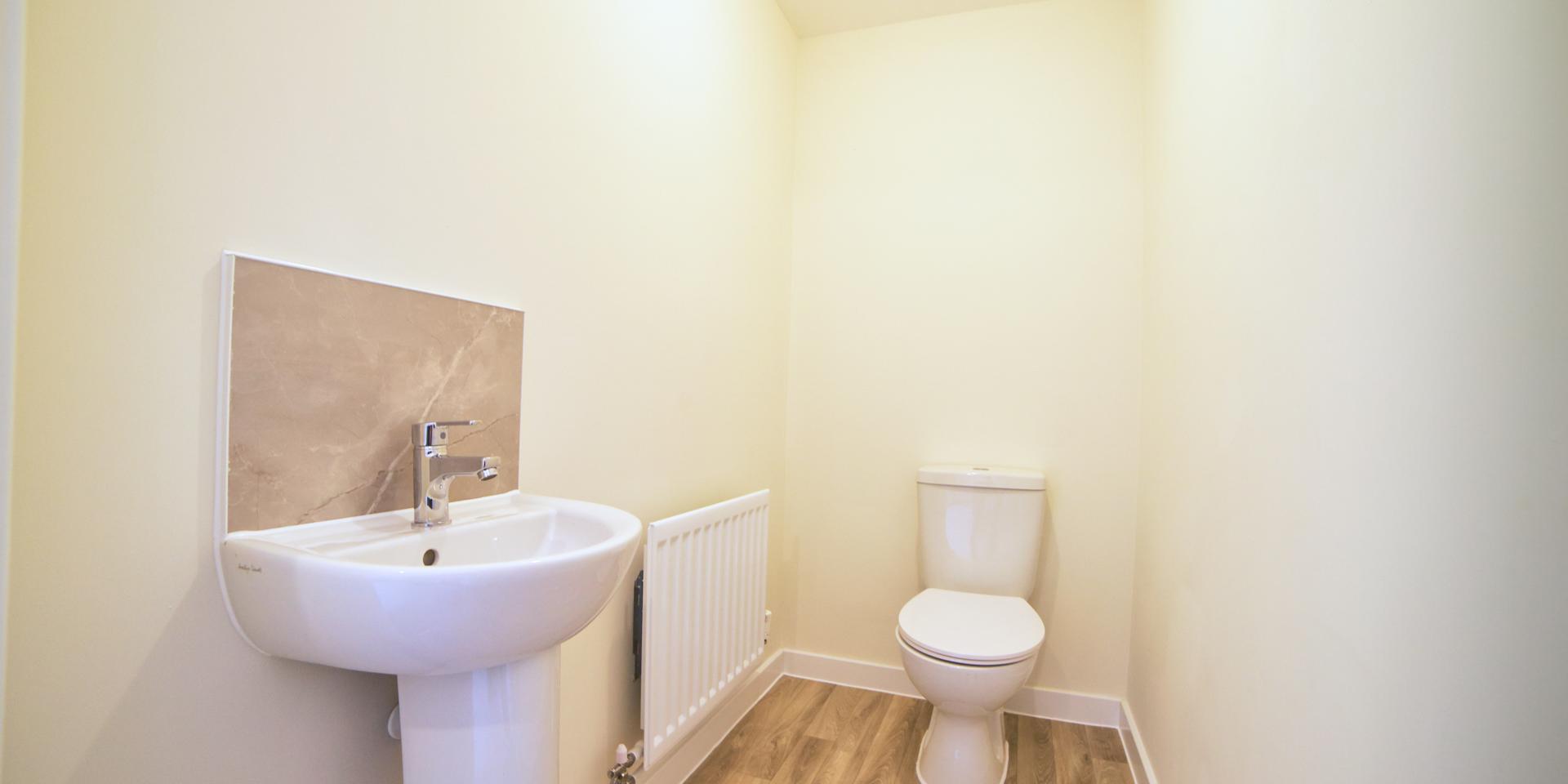 The downstairs cloakroom with wash hand basin and toilet