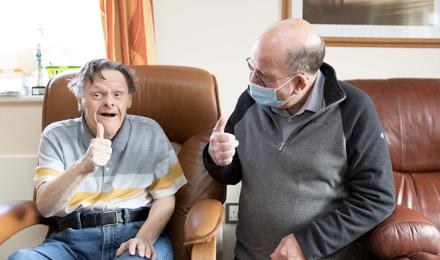 Hightown service user with Support Worker giving the thumbs up