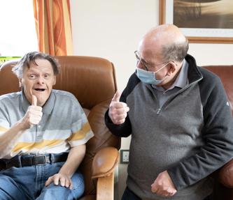 Hightown service user with Support Worker giving the thumbs up