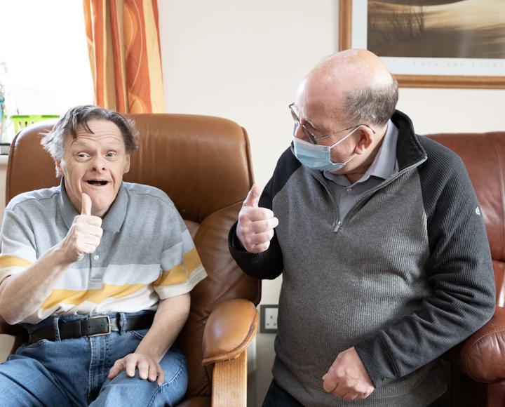 Hightown service user with Support Worker giving the thumbs up