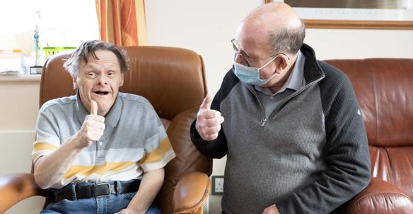 Hightown service user with Support Worker giving the thumbs up