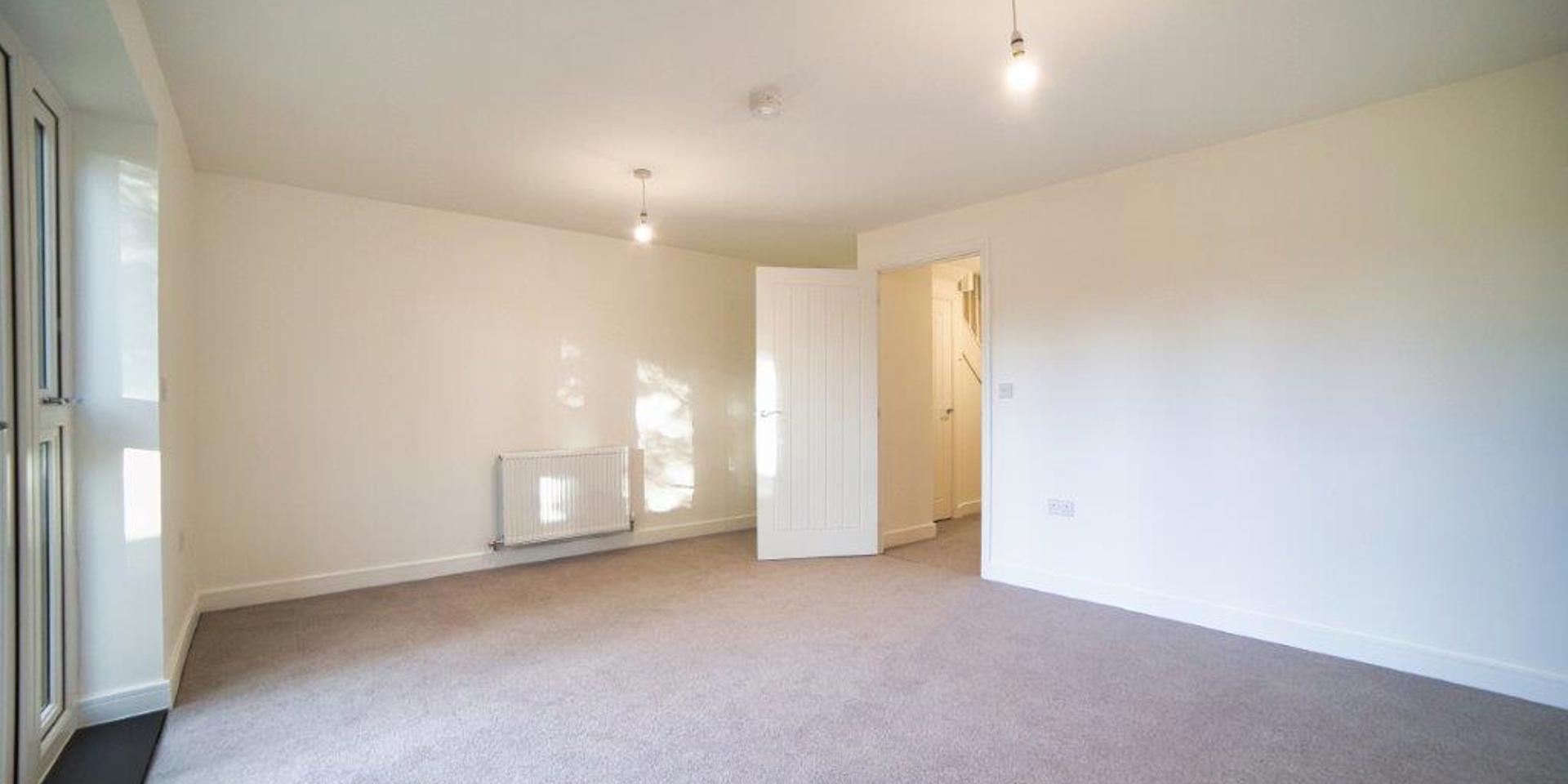 View across the living dining room showing the doorway into the room