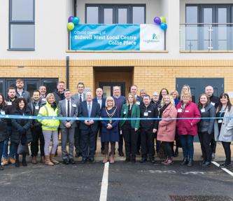 Central Bedfordshire Councillors and Hightown staff standing in front of new homes and a Hightown branded ribbon in front of them.