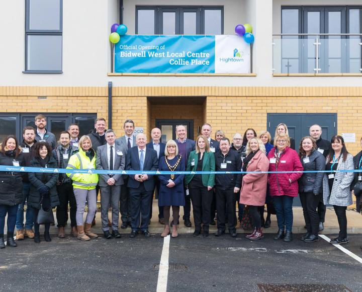 Central Bedfordshire Councillors and Hightown staff standing in front of new homes and a Hightown branded ribbon in front of them.