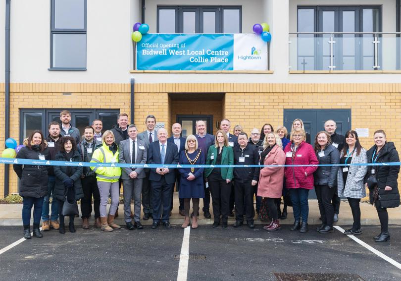 Central Bedfordshire Councillors and Hightown staff standing in front of new homes and a Hightown branded ribbon in front of them.