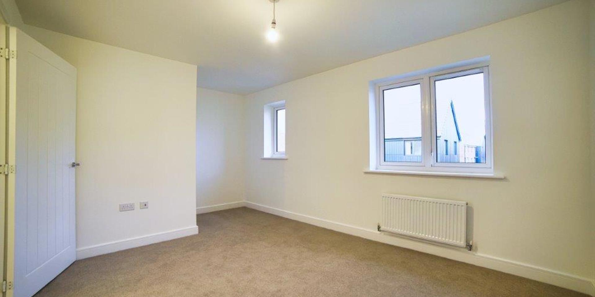 Image of the main bedroom with its two windows
